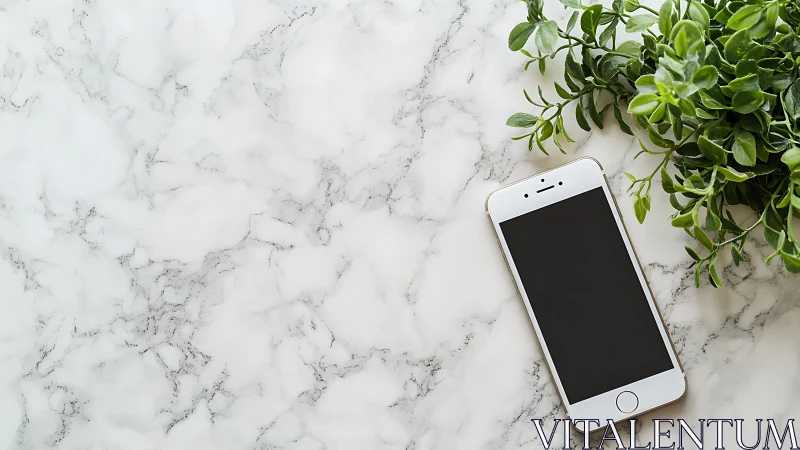 Smartphone on marble workspace with foliage contrast framing.