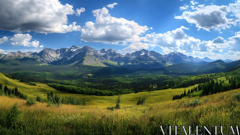 Mountain range with grassy valley under scattered clouds.