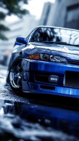 Blue sports coupe is parked on wet urban street in rain