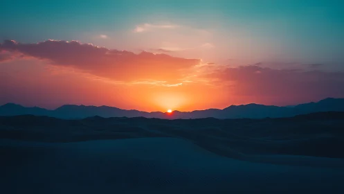 Low-angle desert sunset with layered dunes and silhouetted ridges