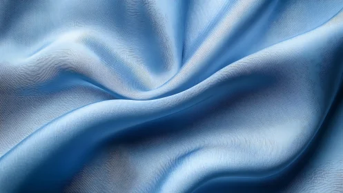 Layered blue fabric with flowing folds and sculptural texture