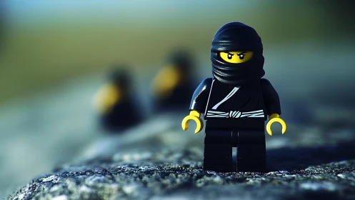 Plastic ninja minifigure stands on textured outdoor surface
