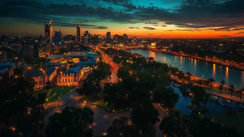 Riverfront city skyline glows under vivid sunset sky
