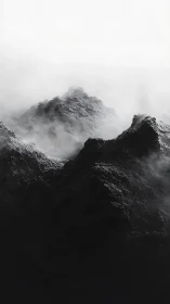 Monochrome volcanic ridges extend upward through dense fog