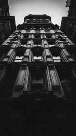 Upward view of ornate high-rise in stark monochrome tones.