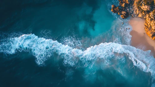 Aerial view captures turquoise surf line curling onto coast