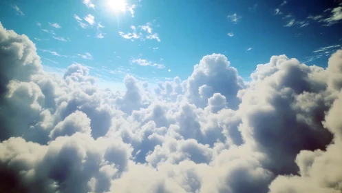 Sunlit cloud kingdom floating softly beneath blue skies.