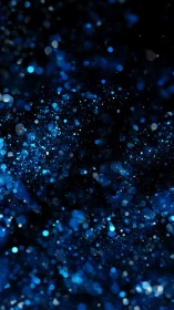 Blue bokeh particle field on dark cosmic background.