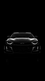 Frontlit Chevrolet performance coupe in low-key black field.