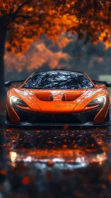 Orange sports car is parked on wet road under autumn trees