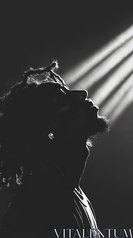 Halo of silence crowns a man in sculpted shadow and light.