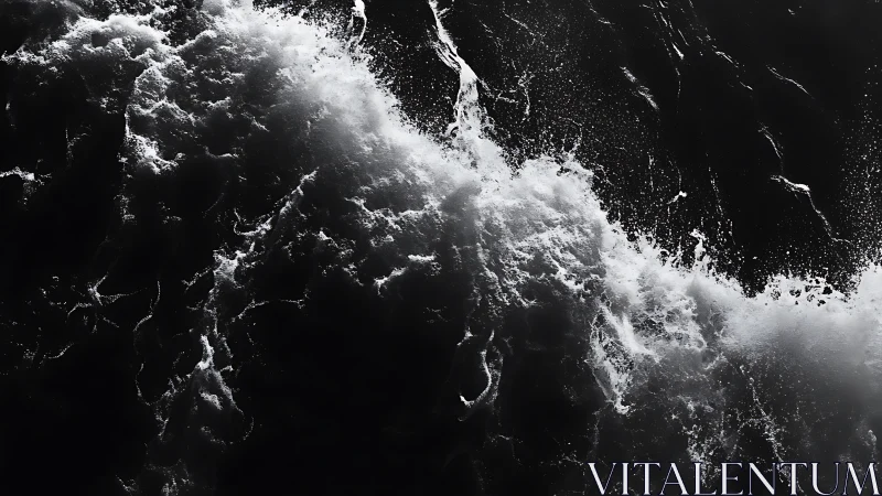 Monochrome overhead view of breaking ocean surface wave.