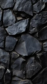 Midnight basalt wall gleams with fractured volcanic rhythm.
