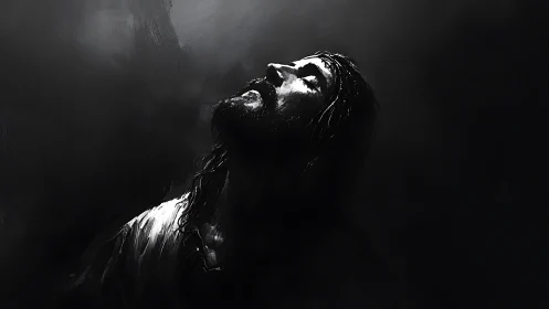 Monochrome chiaroscuro portrait in upward luminance gradient.