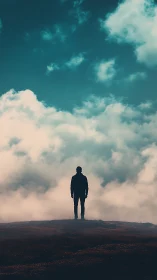 Quiet silhouette gazing into a dreamy teal sky of clouds.