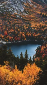Mountain lake bordered by dense autumn forest and granite slopes.