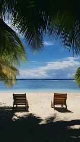 Two Lounge Chairs on Pristine Beach Under Palm Trees