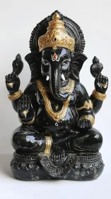 Midnight black Ganesha idol with luminous golden grace.