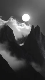 Monochrome lunar halo over serrated alpine ridgeline.