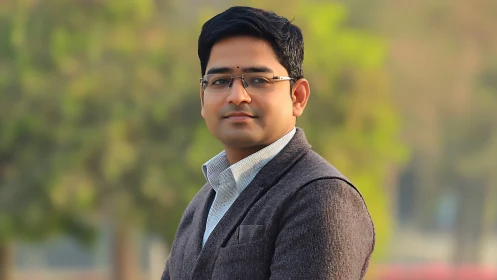 Outdoor portrait of confident professional in soft focus park.