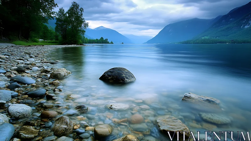 Long exposure alpine lake study with misted foreground stones