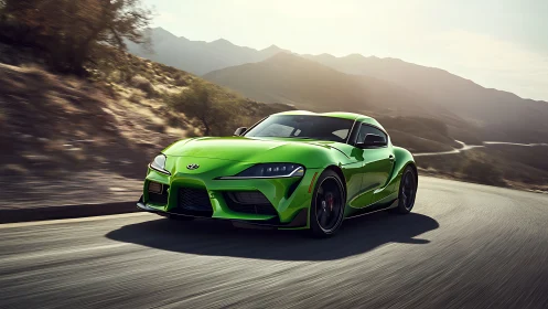 Green sports coupe driving on winding mountain highway.