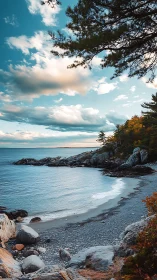 Rocky cove shoreline with calm sea and scattered clouds.