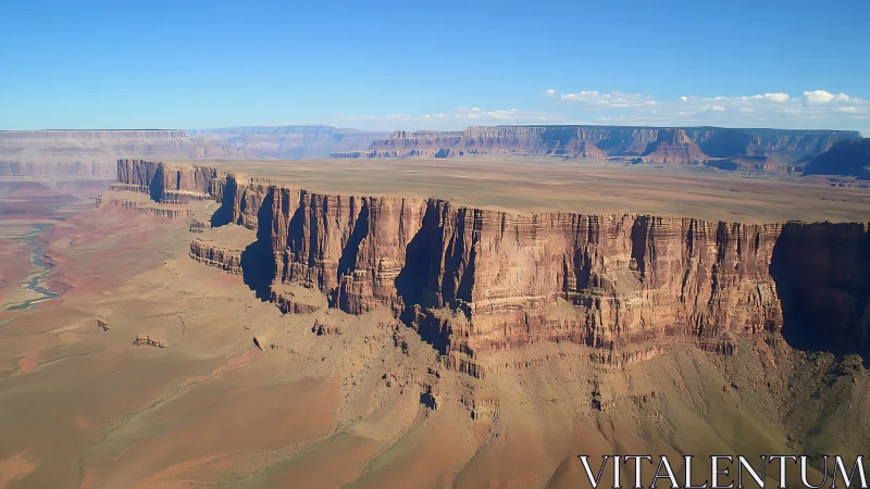 Sheer sandstone escarpment reveals stratified desert plateau erosion
