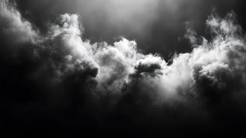 Brooding storm clouds gather in a dramatic monochrome sky