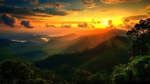 Layered forested mountains under intense sunset light.