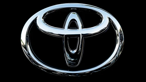 Highly polished chrome automotive emblem rendered on black ground