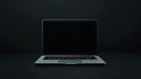 Minimalist laptop front view on dark studio background.