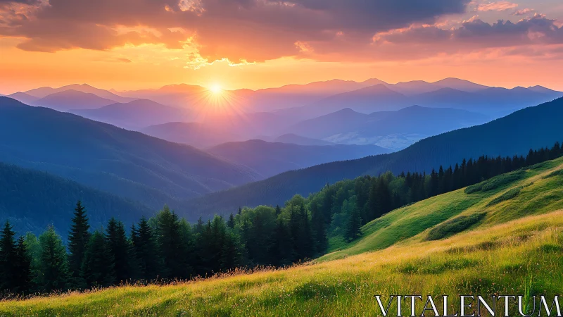 Sunset illuminates layered mountain ridges and grassy slope