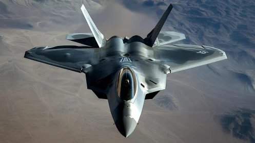 Stealth fighter jet in flight over desert landscape.
