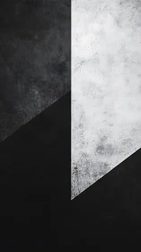 Monochrome geometric division with textured triangular forms.