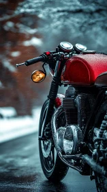 Red motorcycle on wet winter road with falling snow showers.