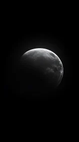 Minimalist lunar crescent in high-contrast monochrome space study.