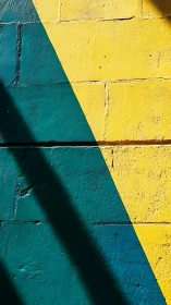 Yellow and teal painted brick wall with bold diagonal line.