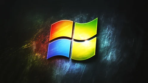 Glossy four-color window logo glows on dark brushed metal