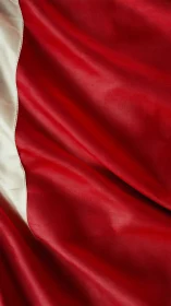 Macro textile analysis of red and white draped fabric field.