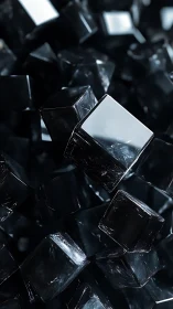 Dark reflective cubes clustered in dense abstract pattern.