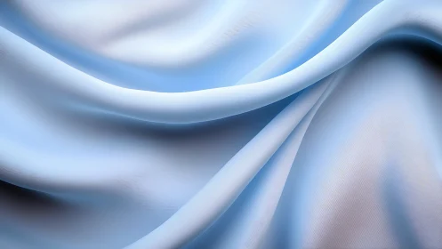 Light blue folded textile surface with smooth draped forms.