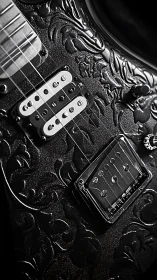 Embossed black electric guitar macro in dramatic side lighting.