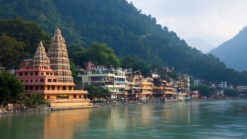 Riverside Hindu temple complex framed by misted Himalayan foothills.