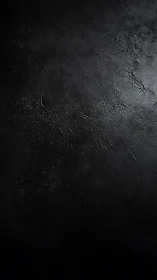 Dark textured concrete surface with subtle worn highlights.