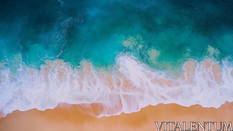 Aerial view of turquoise waves meeting sandy shoreline.