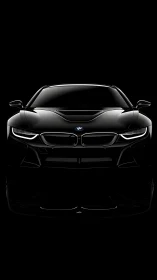 Front elevation of black BMW coupe in high-contrast lighting