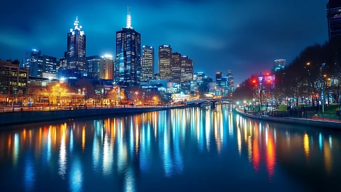 Night city skyline reflects sharply on calm riverside water