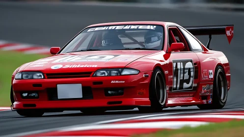 Red race-prepared coupe negotiates corner on track surface
