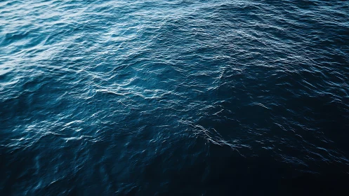 Textured deep ocean surface with directional ripples and glare